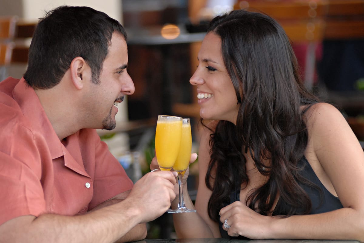 A couple toasting over dinner