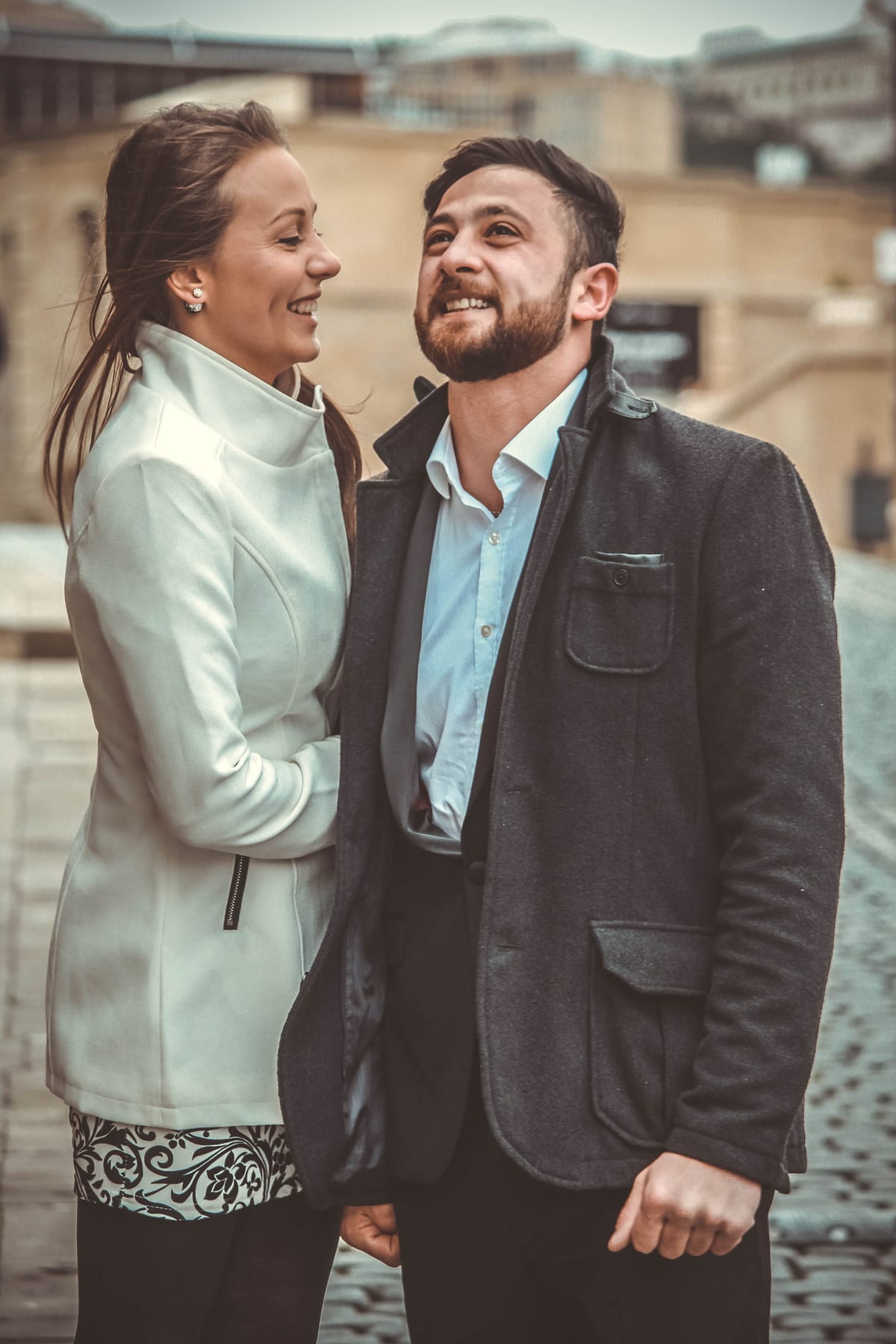 A well-dressed couple sharing a moment